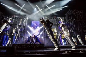 Michael Jackson tribute shows. Leaning forward with other dancers.