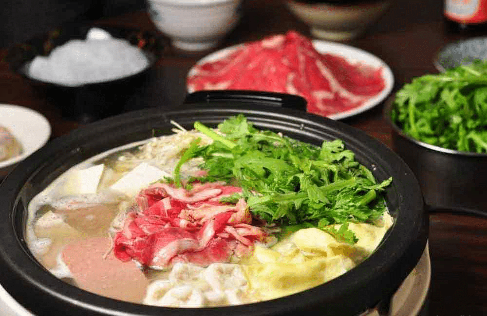 Arugula, tofu, and beef in a clear broth at The Golden Pot in Las Vegas
