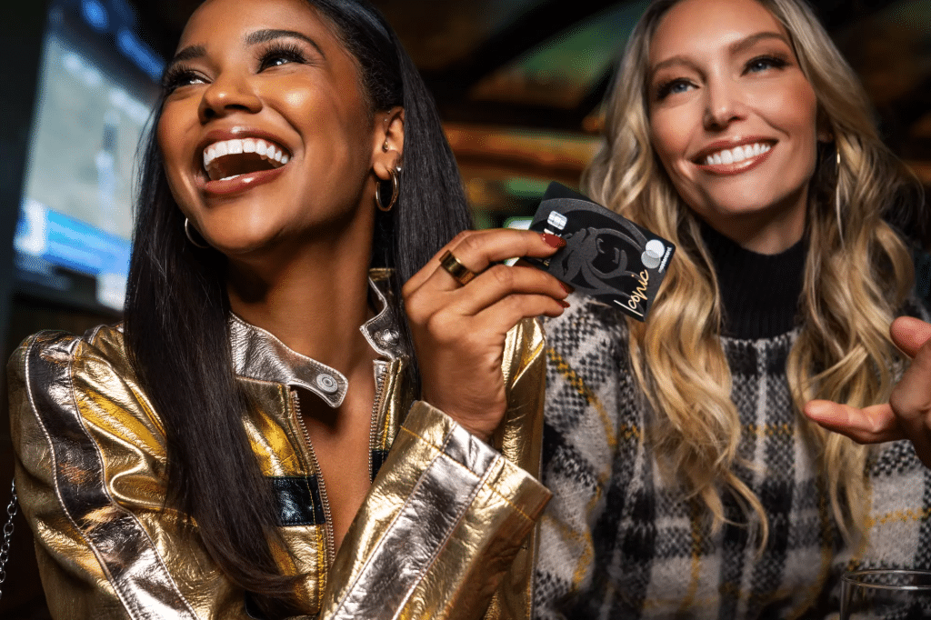 Woman hold MGM Rewards Iconic credit card