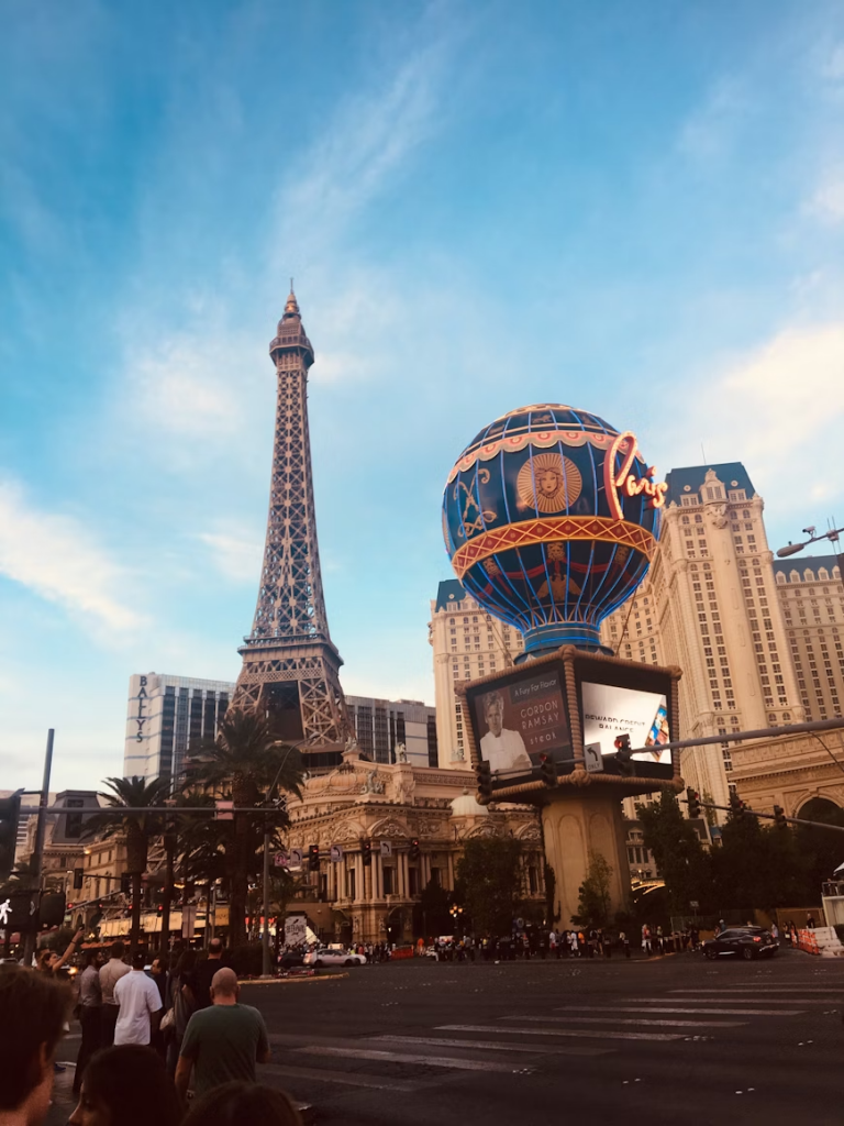 People walking on the Las Vegas Strip with Paris Las Vegas visible. 